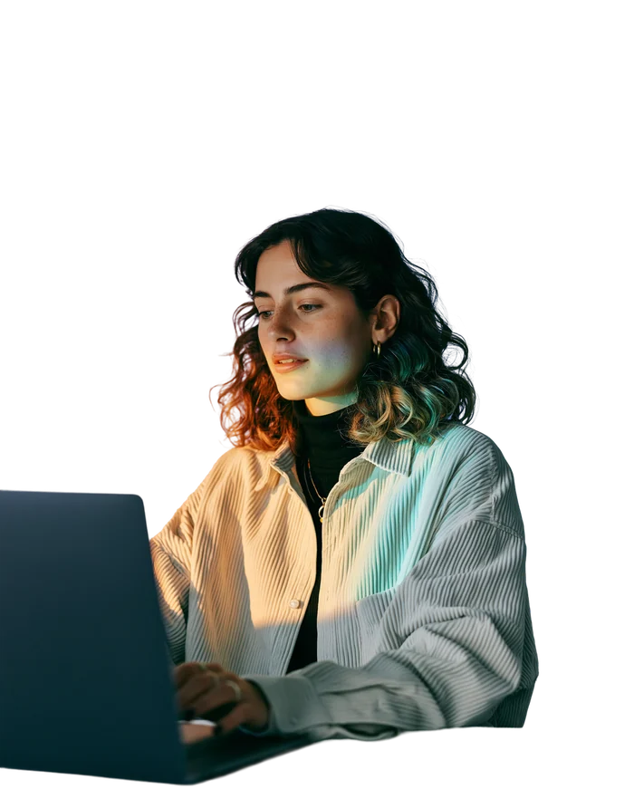 An affiliate manager working at a laptop in warm side light